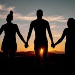 Hands gently holding a heart symbolizing kindness and service