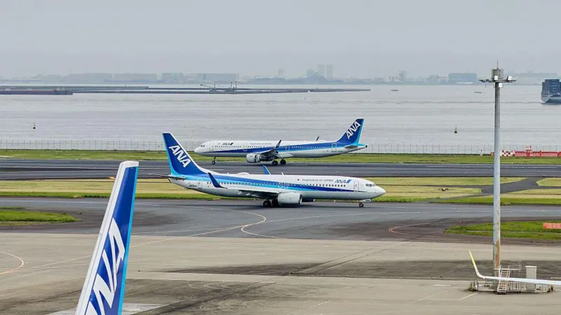 ANA flight emergency landing after passenger attempted to open the door mid-air.