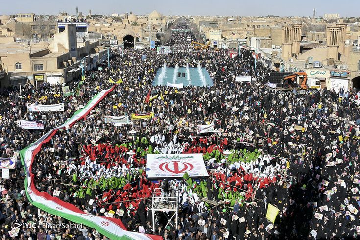 Flags of the United States and Iran with a nuclear symbol in the background, representing diplomatic negotiations over nuclear weapons.