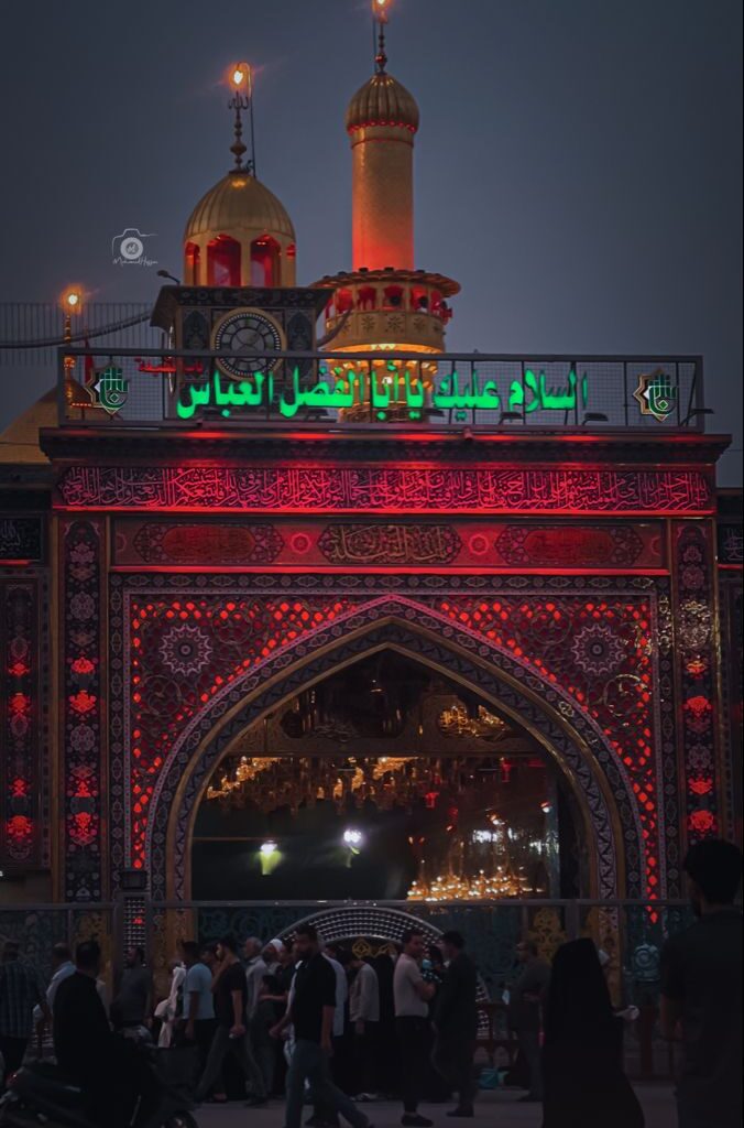 A sorrowful crowd commemorating Muharram, holding black flags in remembrance of Imam Hussain (A.S.) and the tragedy of Karbala