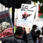 A protester holds a sign during a Palestine Action demonstration in Trafalgar Square, London, against the UK government’s proscription of the group.