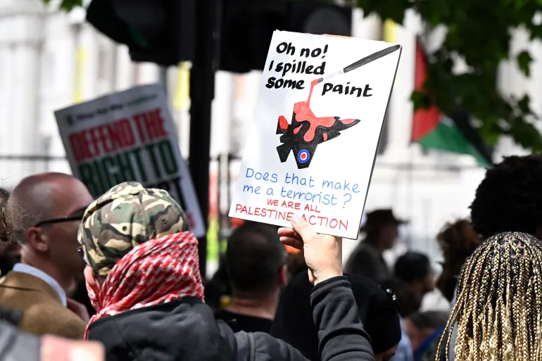 A protester holds a sign during a Palestine Action demonstration in Trafalgar Square, London, against the UK government’s proscription of the group.