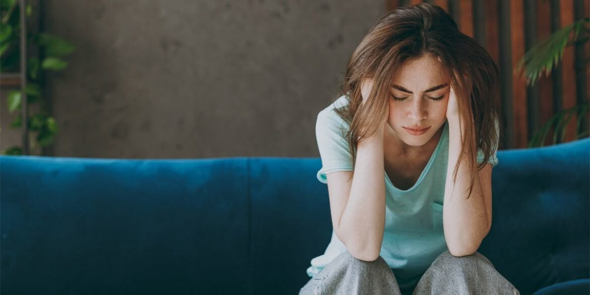 Silhouette of a solitary figure standing amid a blurred, fast-moving crowd, symbolizing emotional isolation and resilience in a busy global world.